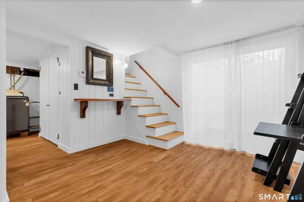 a view of entryway and hall with wooden floor