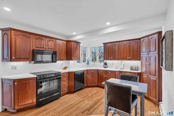 a kitchen with granite countertop wooden cabinets and stainless steel appliances