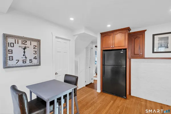 a view of kitchen with refrigerator and wooden floor