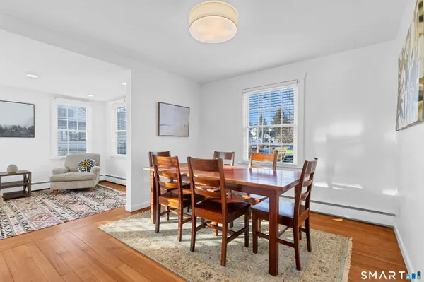 a view of a dining room with furniture and wooden floor