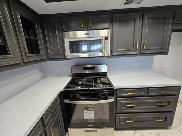 a stove top oven sitting inside of a kitchen