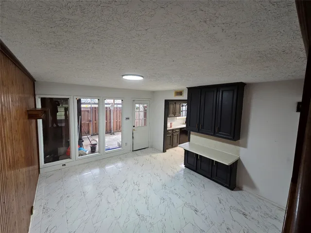 a view of an empty room and closet with wooden floor