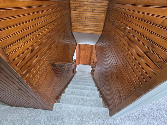 a view of a roof deck with wooden floor and fence