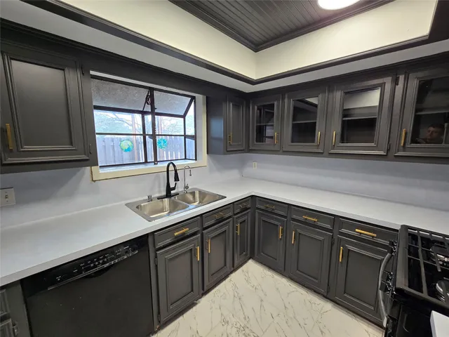 a kitchen with a sink and cabinets