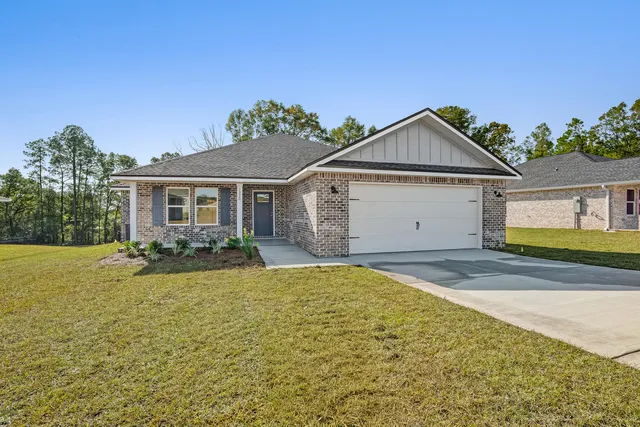 a view of a house with a yard and garage