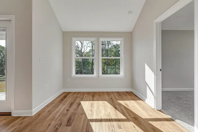 a view of wooden floor in a room next to a window