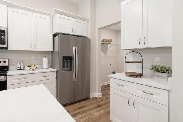a kitchen with stainless steel appliances granite countertop a refrigerator sink and cabinets