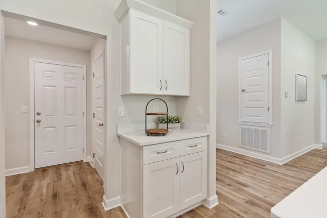 a room with white cabinets and sink