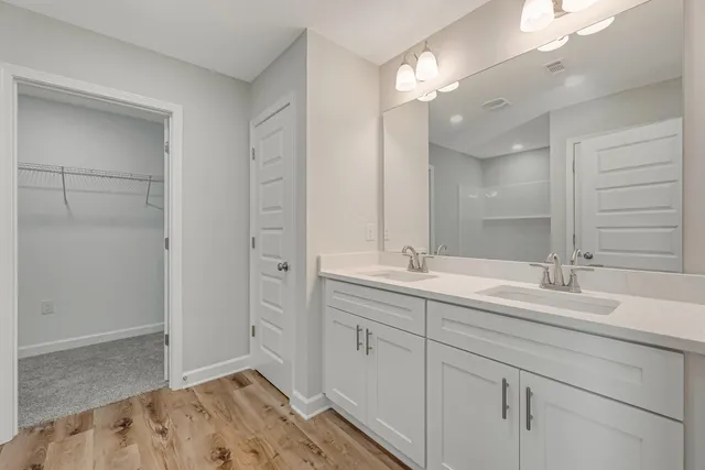 a bathroom with a sink double vanity and a mirror