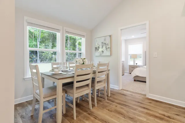 a dining room with furniture and window
