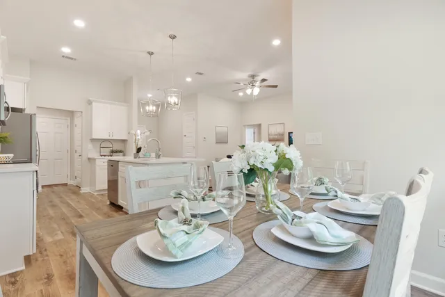 a dining room with furniture and a kitchen view