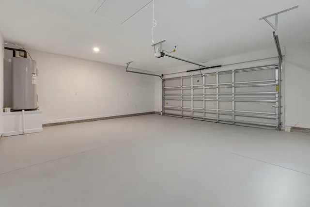 a front view of house with yard and trees in the background