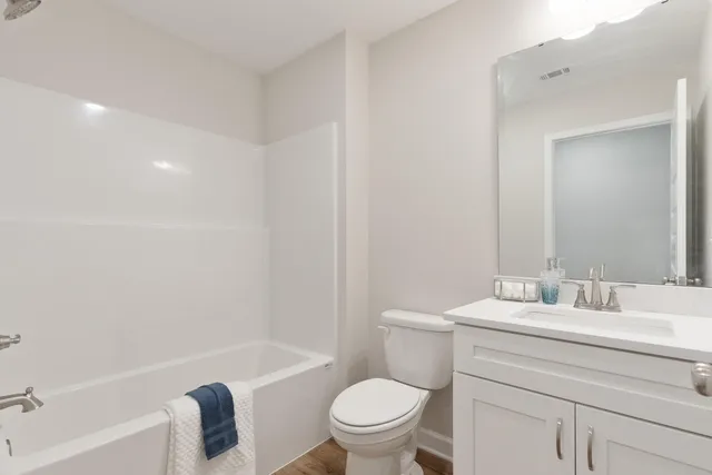 a bathroom with a sink a toilet and a bathtub