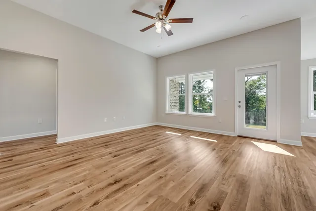 wooden floor in an empty room with a window