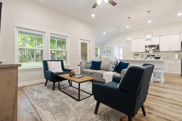 a living room with furniture and a wooden floor