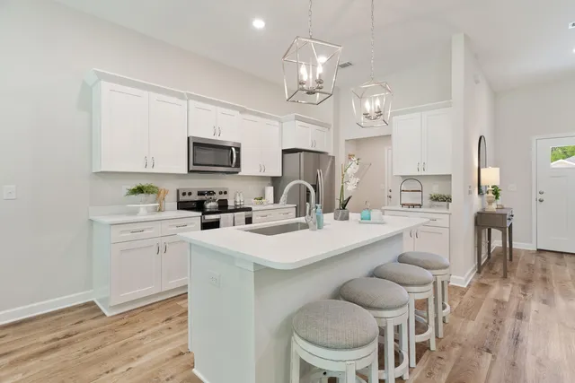 a kitchen with a sink stove and microwave
