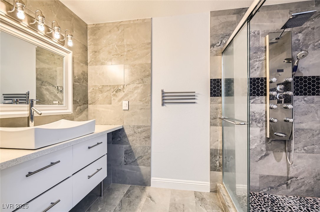 4347 South Mojave Road Las Vegas, NV 89121 - Photo 7 of 20 Full bathroom featuring a stall shower, vanity, and tile walls
