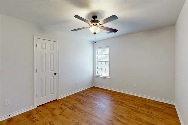 a view of a livingroom with a ceiling fan and wooden floor
