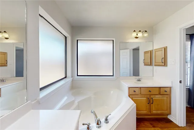 a bathroom with a bathtub and a sink