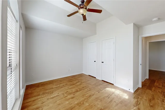 a view of a room with a ceiling fan and a window