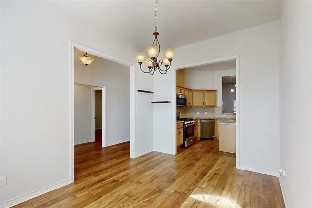 a view of a kitchen with a sink and a refrigerator