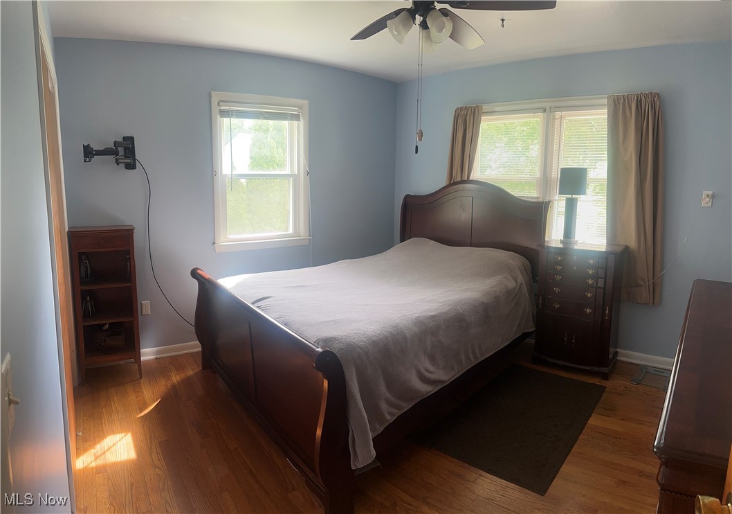 379 Wilson Mills Road Chardon, OH 44024 - Photo 11 of 20 Bedroom with wood finished floors, multiple windows, and baseboards