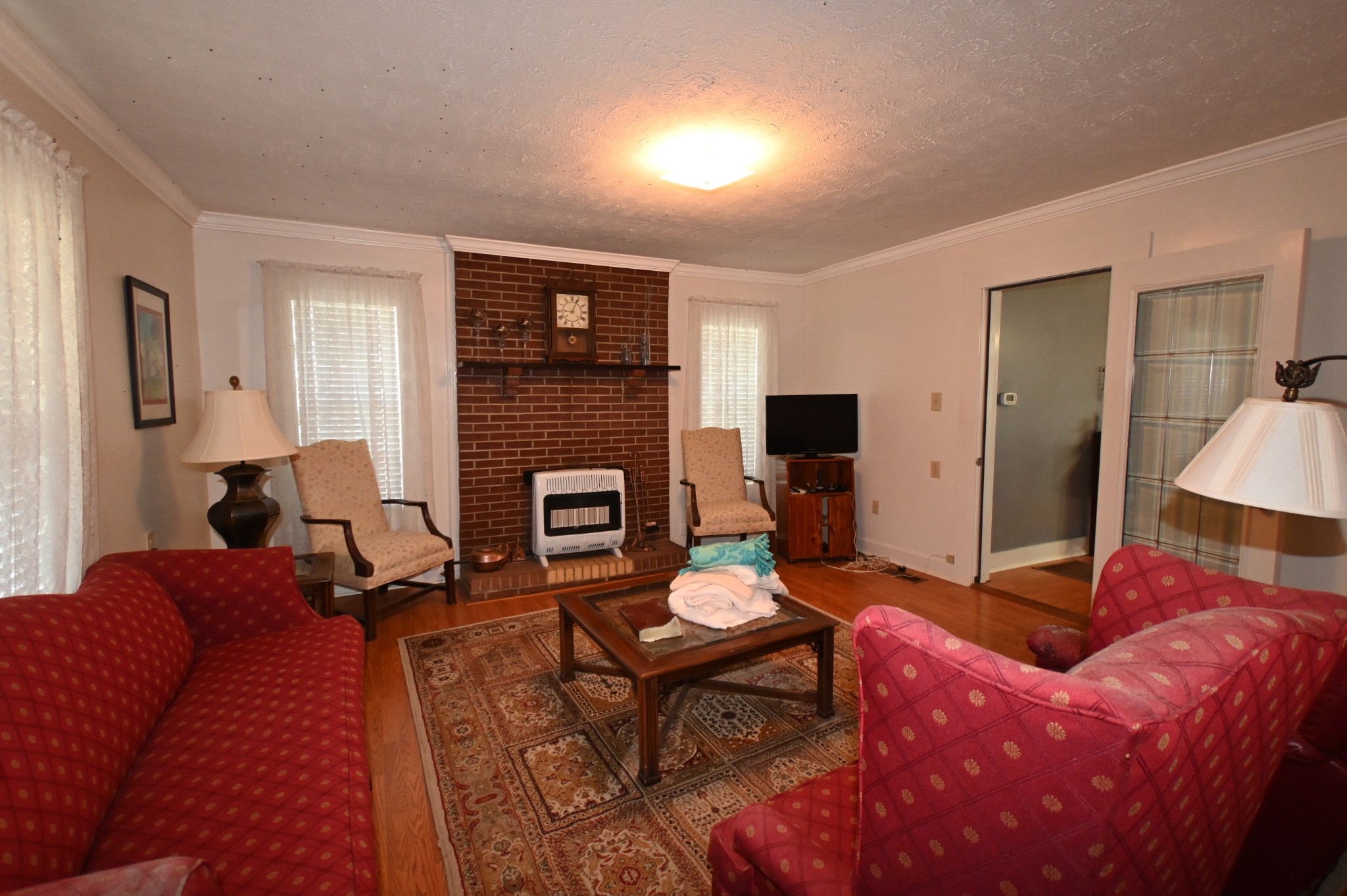 489 Doyle Road Linden, TN 37096 - Photo 15 of 70 a living room with furniture a fireplace and a flat screen tv