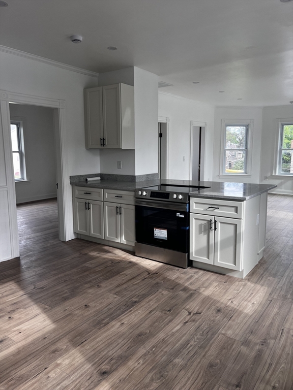 19 Reeves Street Worcester, MA 01607 - Photo 8 of 30 a kitchen with stainless steel appliances granite countertop a stove top oven and sink