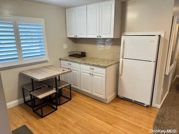 a kitchen with a refrigerator and a stove top oven