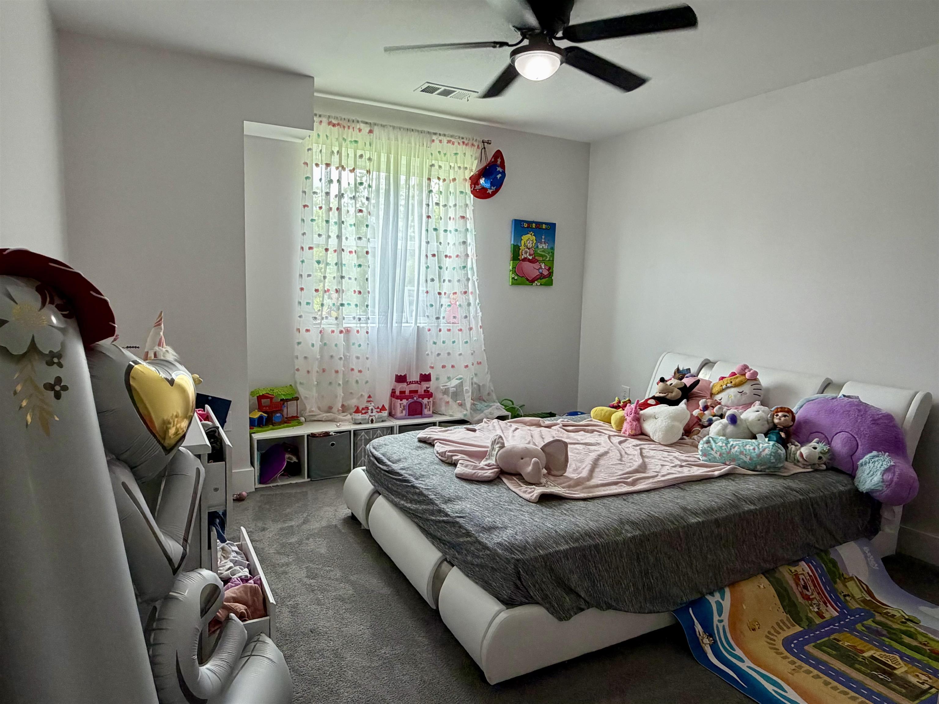 3670 Peavine Road Middleton, TN 38052 - Photo 27 of 36 Carpeted room with a ceiling fan, a window featuring sheer curtains, and built-in storage cubbies