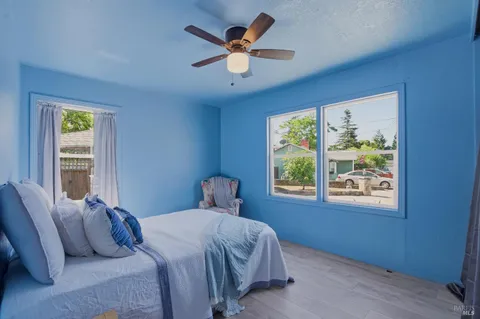 a bedroom with a large bed and a window