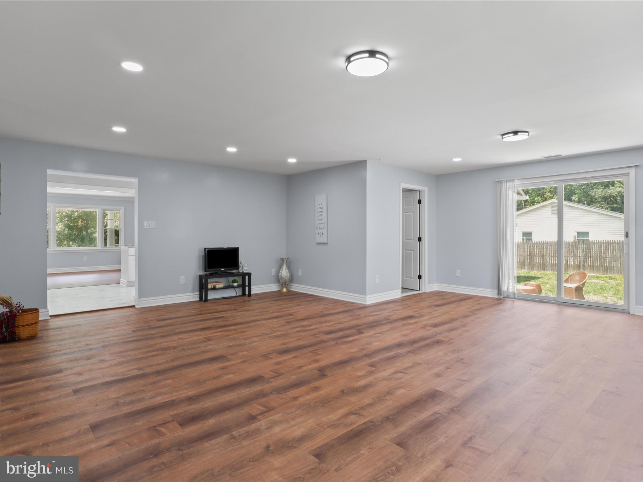 8211 Hocking Place Alexandria, VA 22309 - Photo 16 of 45 a view of an empty room with wooden floor and a window