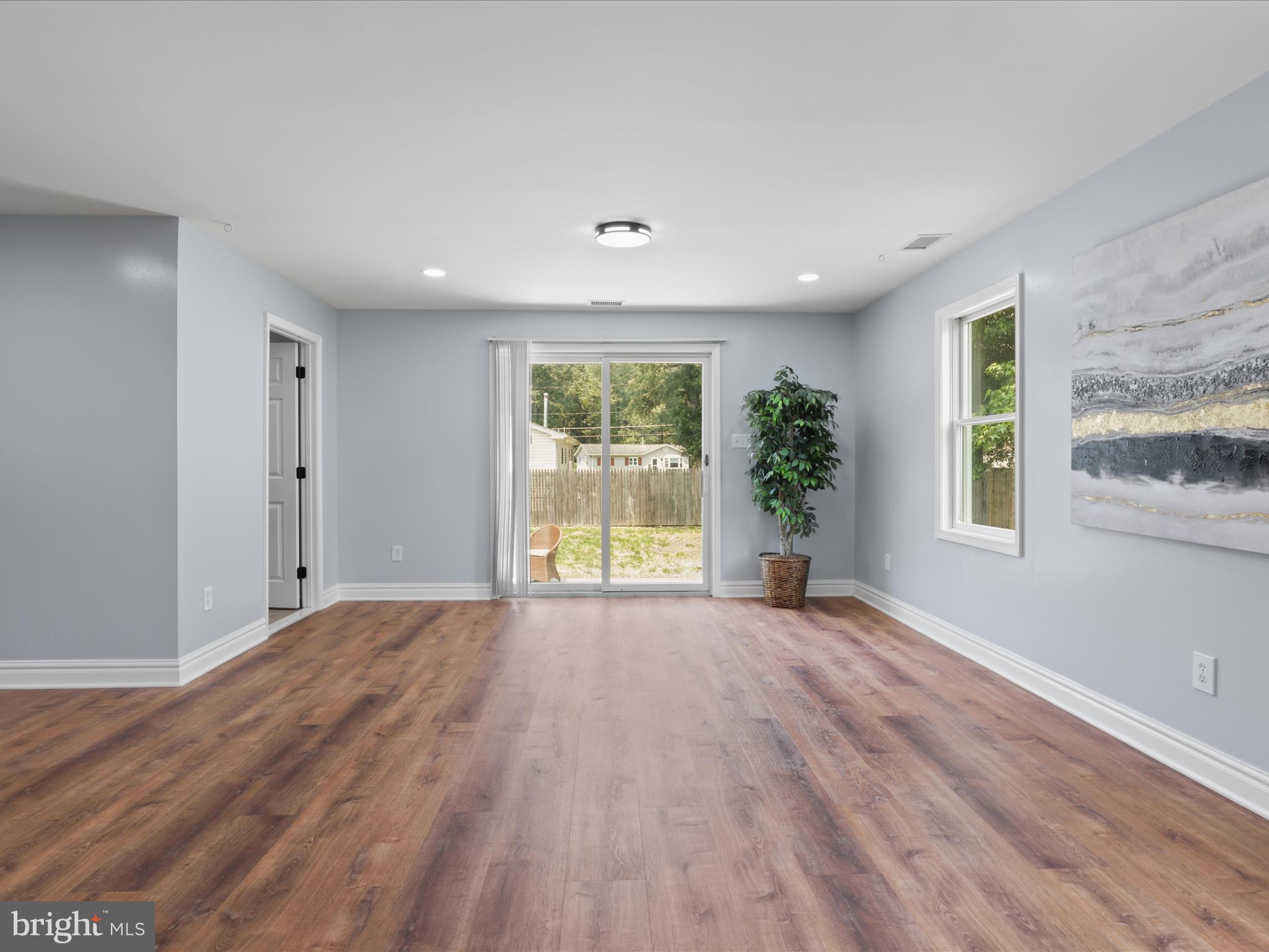 8211 Hocking Place Alexandria, VA 22309 - Photo 17 of 45 a view of a big room with wooden floor and windows