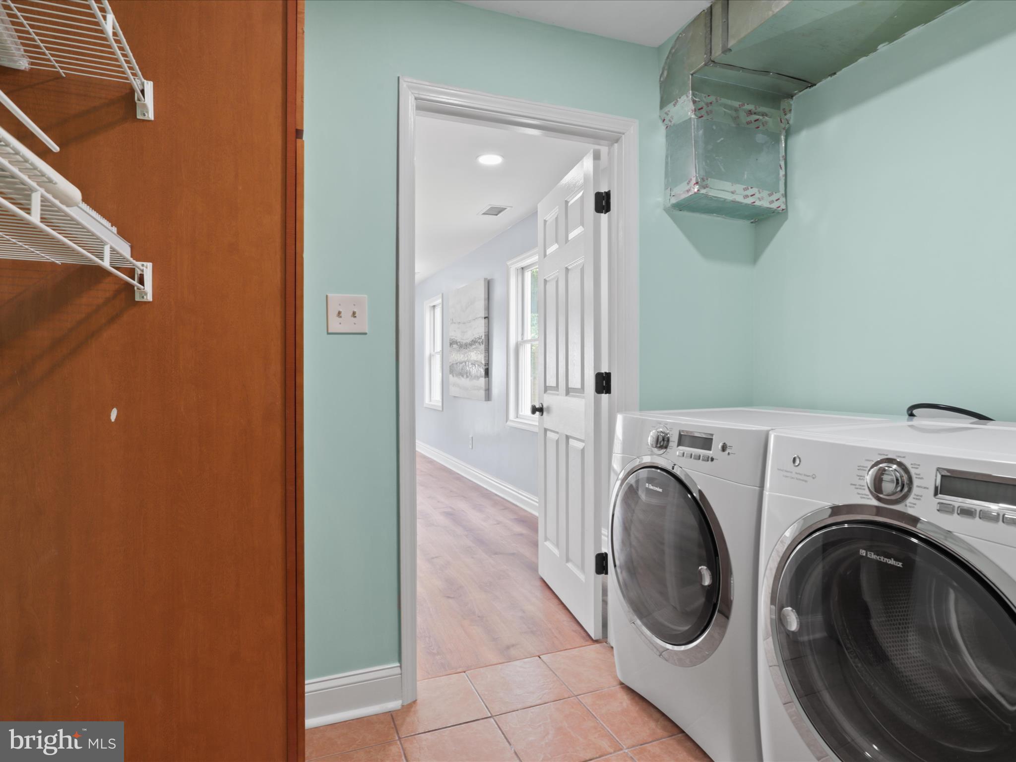 8211 Hocking Place Alexandria, VA 22309 - Photo 21 of 45 a view of a hallway with washer and dryer