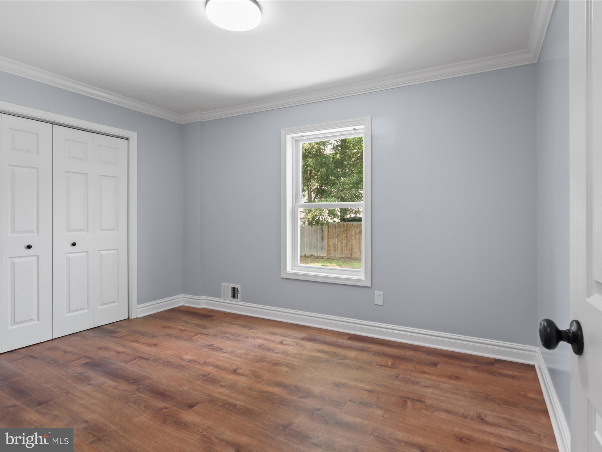 8211 Hocking Place Alexandria, VA 22309 - Photo 28 of 45 a view of empty room with wooden floor and fan