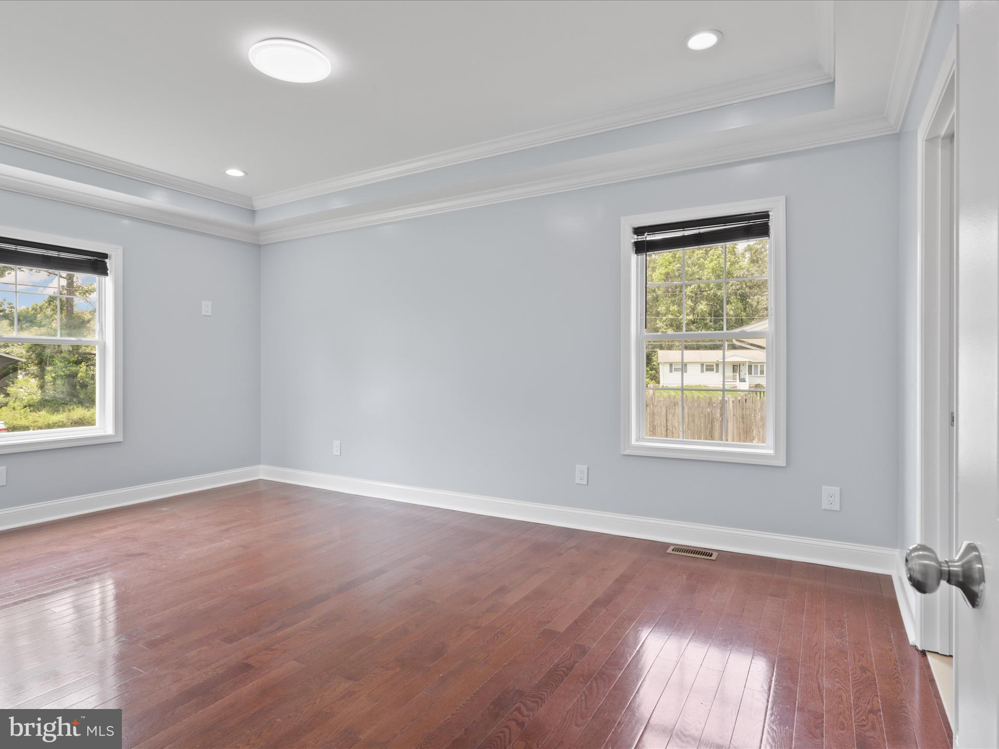 8211 Hocking Place Alexandria, VA 22309 - Photo 30 of 45 an empty room with wooden floor and windows