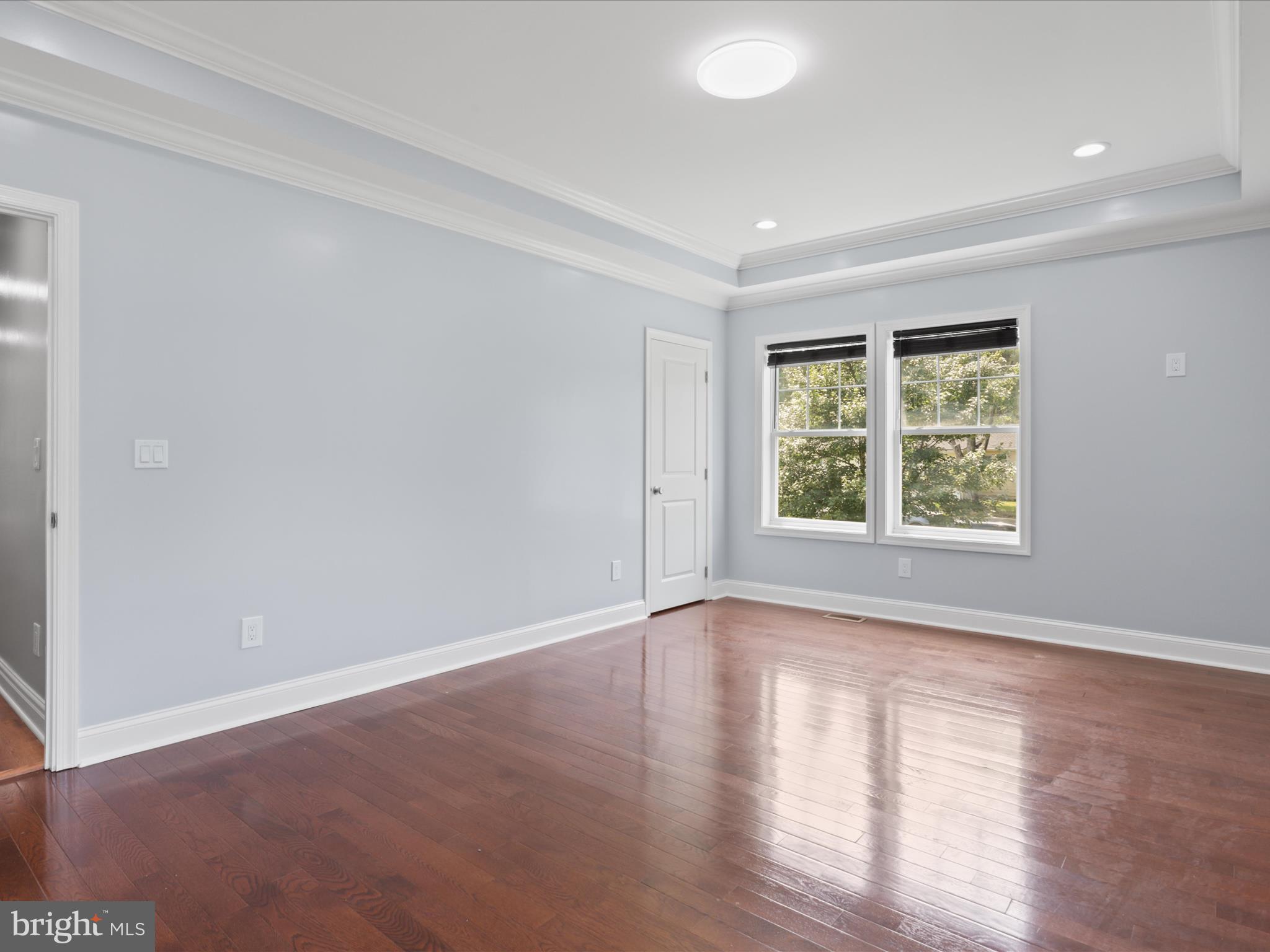 8211 Hocking Place Alexandria, VA 22309 - Photo 31 of 45 an empty room with wooden floor and windows