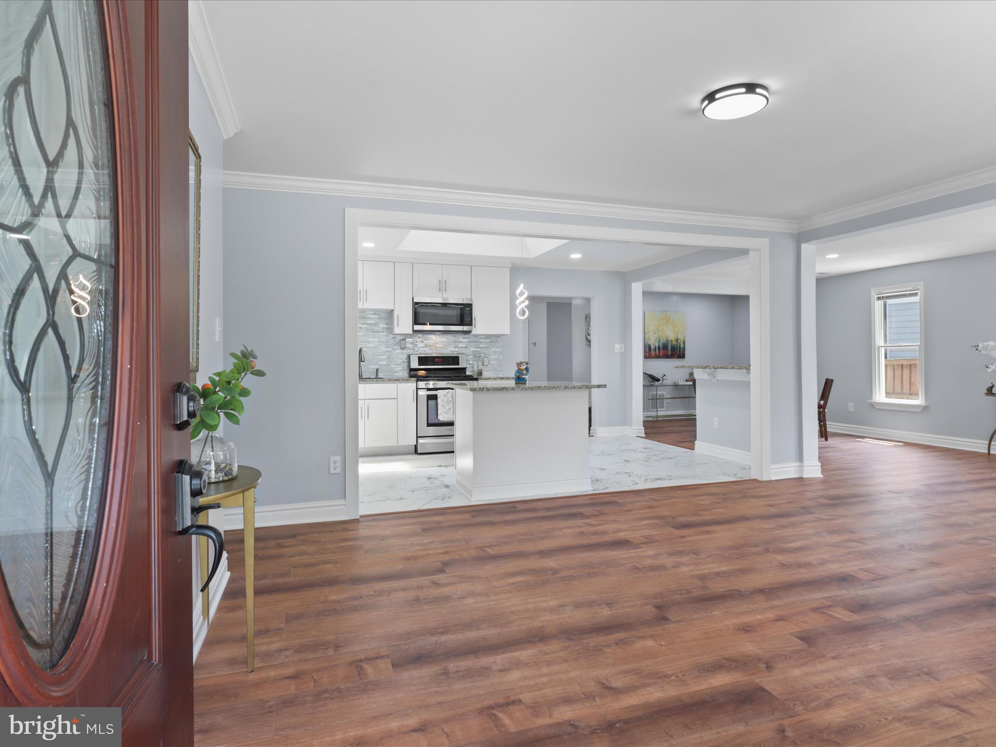8211 Hocking Place Alexandria, VA 22309 - Photo 6 of 45 a view of a living room and kitchen with wooden floor