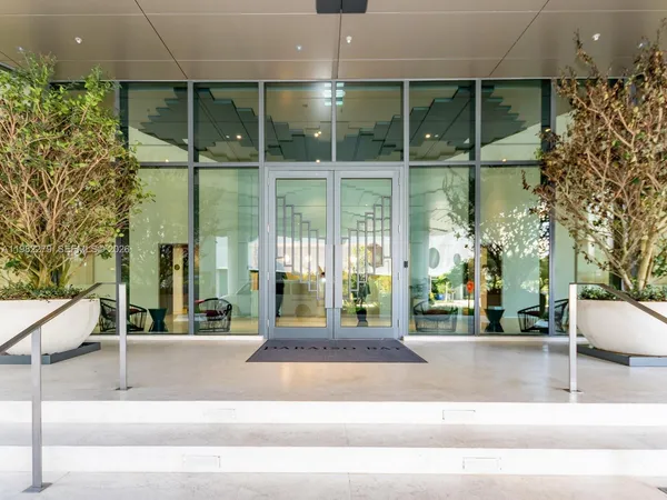 a building exterior with glass windows and door