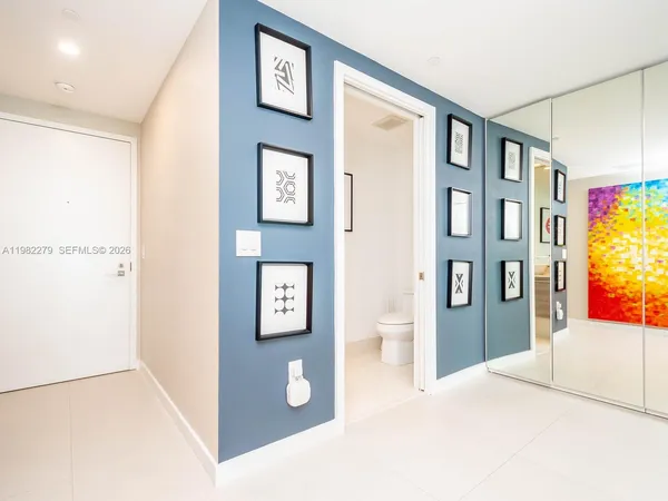 a view of an entryway with wooden floor