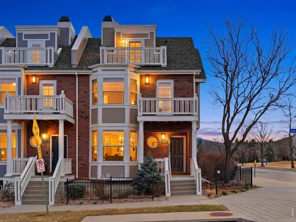 a front view of a residential apartment building with a yard