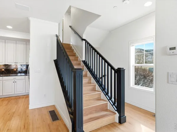 a view of entryway with wooden floor and stairs