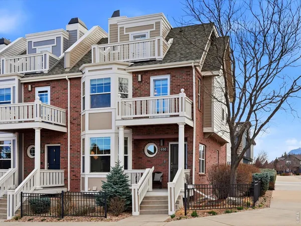a front view of a residential apartment building with a yard