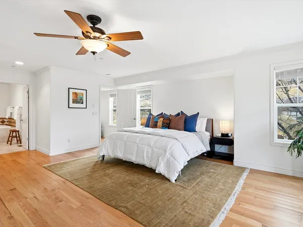 a bedroom with a large bed and a chandelier