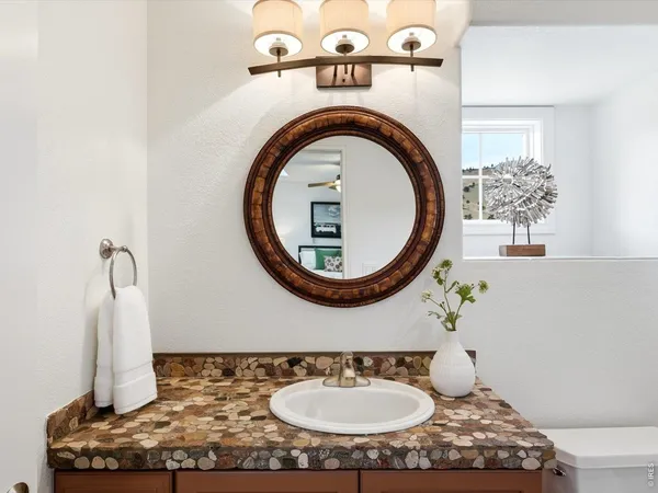 a bathroom with a sink a mirror and a toilet