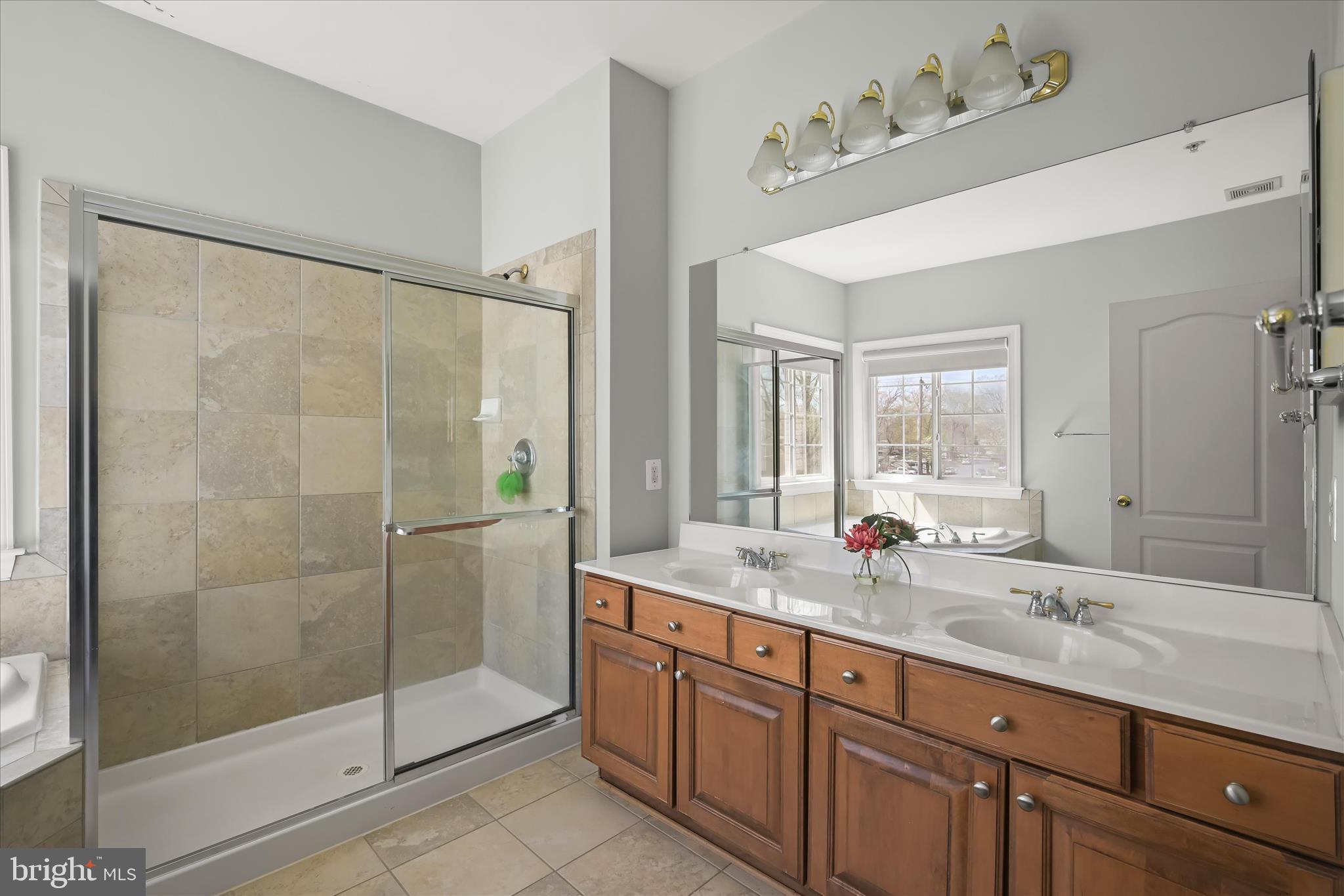 2311 Abby Road Edgewater, MD 21037 - Photo 19 of 46 a bathroom with a shower sink and mirror
