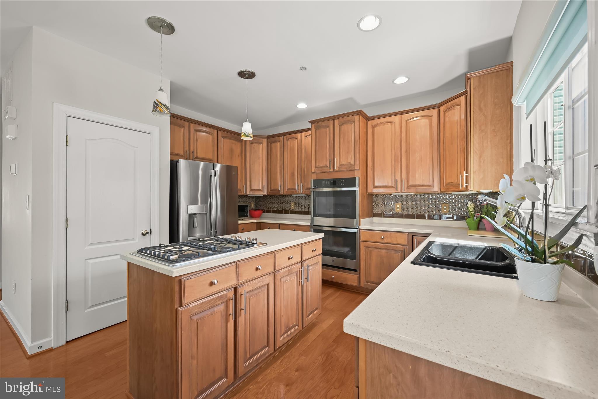 2311 Abby Road Edgewater, MD 21037 - Photo 3 of 46 a kitchen with stainless steel appliances granite countertop a sink a stove a refrigerator a center island and cabinets