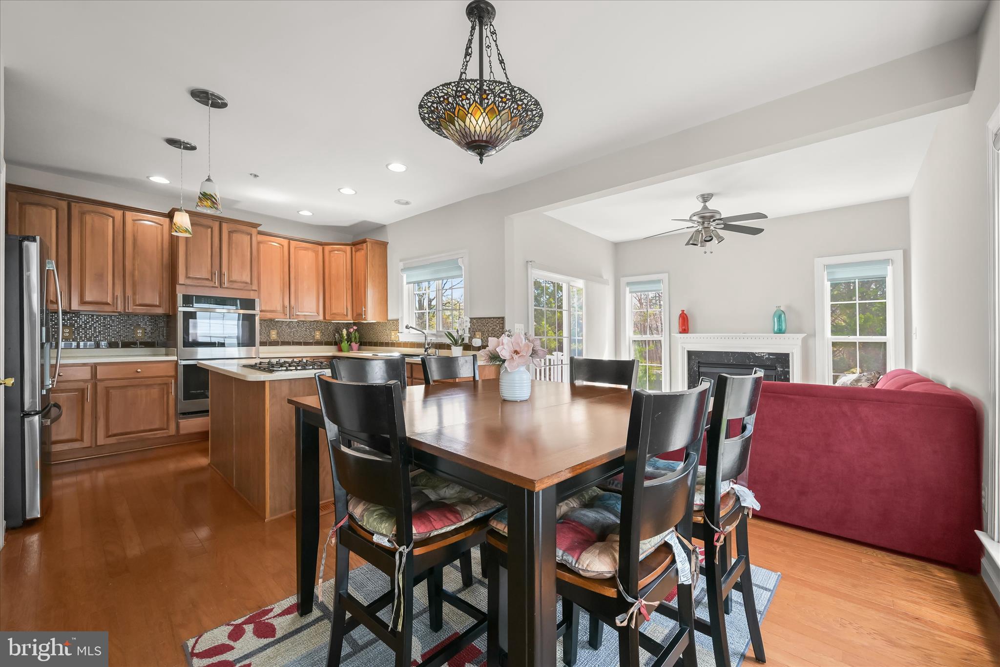 2311 Abby Road Edgewater, MD 21037 - Photo 8 of 46 a kitchen with stainless steel appliances granite countertop a dining table chairs refrigerator and microwave
