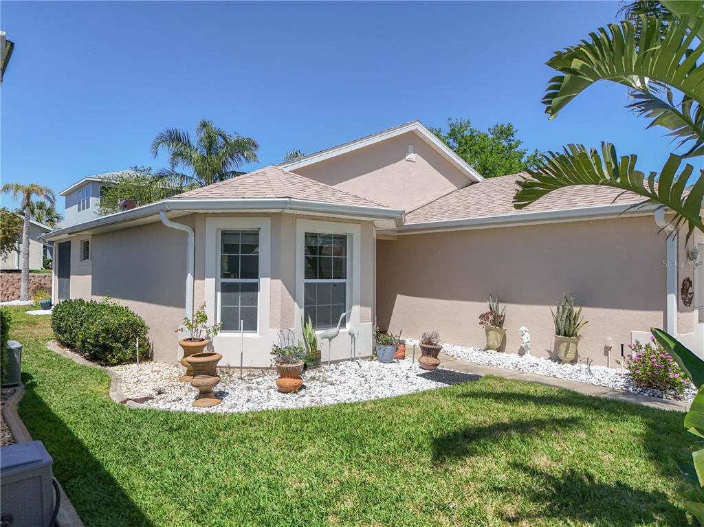 5441 Sea Leopard Street Tavares, FL 32778 - Photo 1 of 1 a view of a house with backyard sitting area and garden