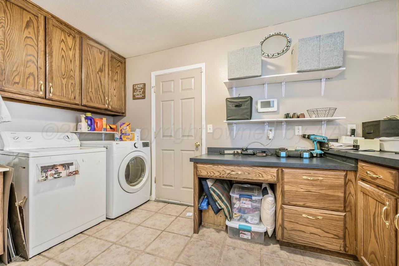 200 Hunters Trail Amarillo, TX 79124 - Photo 11 of 23 a utility room with cabinets dryer and washer